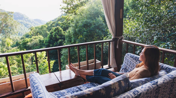 istock A young woman lying and relaxing on sofa while looking at a beautiful nature view 1326912801