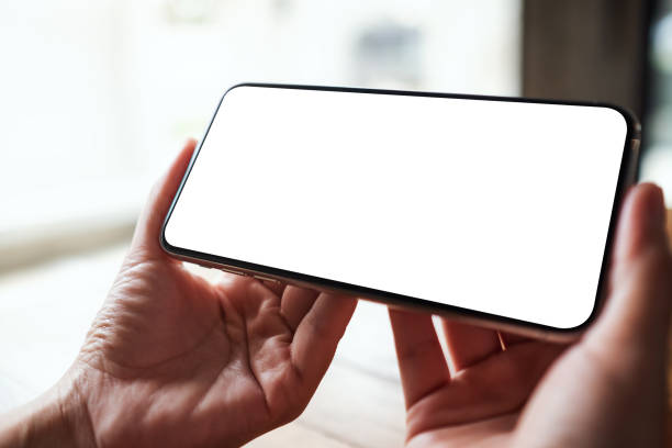 istock a woman holding mobile phone with blank white desktop screen 1326912812