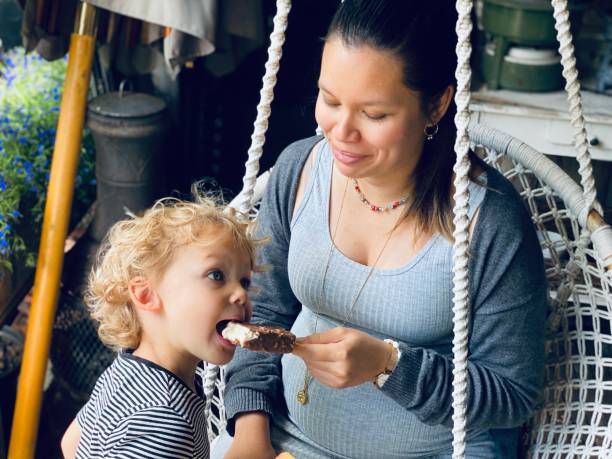 Pregnant mother with son eating ice cream