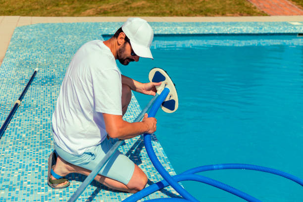 istock Man cleaning the swimming pool 1326913311