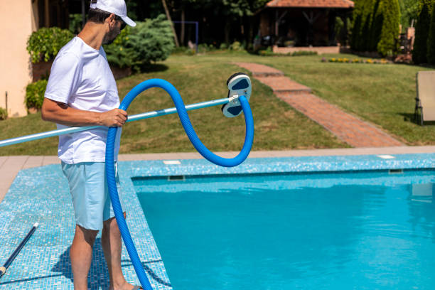 istock Man cleaning the swimming pool 1326913322