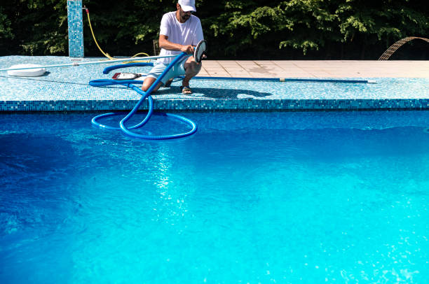 istock Man cleaning the swimming pool 1326913842