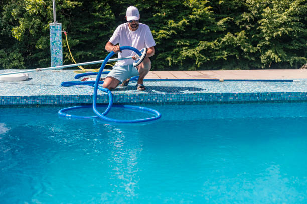 istock Man cleaning the swimming pool 1326913843
