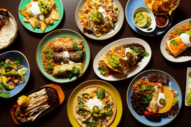 typical mexican food, tacos, tamales, guacamole, tostadas, fajitas, top view on wooden background - mexican dish imagens e fotografias de stock