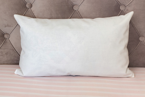 White lumbar pillow on a couch, case Mockup. Interior photo