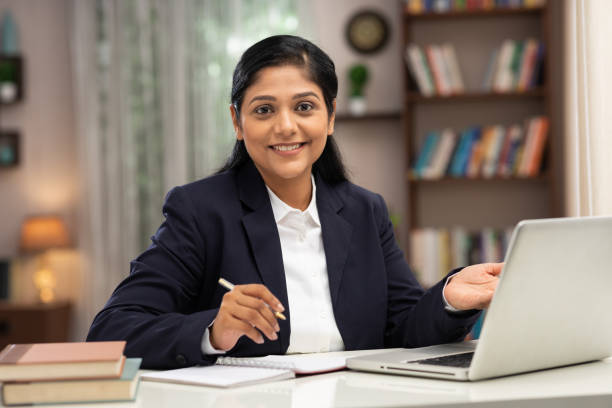 shot of a business women using laptop working at home:- stock photo - lawyer young adult suit expressing positivity imagens e fotografias de stock