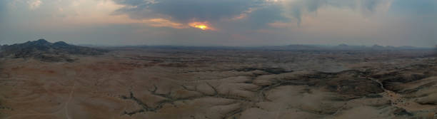 istock Dramatic sunset over the Namibian desert. The sun is peeping through the clouds 1326921545