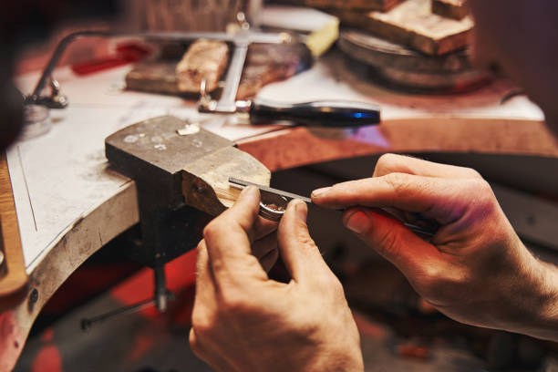 istock Jeweler is polishing workpiece with hand file 1326921880
