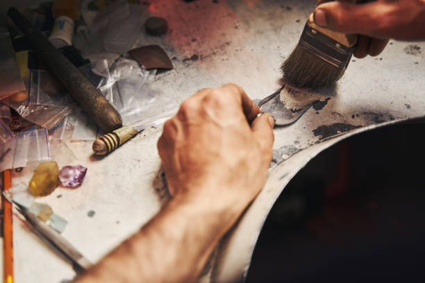 istock Jeweler sweeping away dust from table to little shovel 1326921882