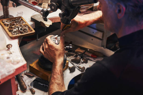 istock Male jewelry expert pushing claws over gem inside ring 1326921955