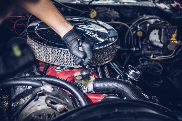 istock Car detailing studio worker cleaning classic car engine 1326923414