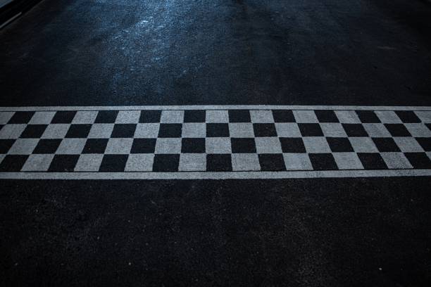 istock Race finish line on black asphalt 1326923720