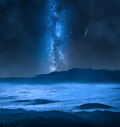 Milky way over foggy walley in Tatra Mountains. Night sky in summer.