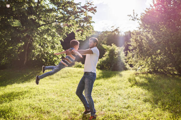 istock Happy father and son spinning around at sunset 1326924573
