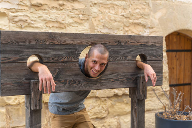 portrait of man in a wooden pillory - pelourinho imagens e fotografias de stock