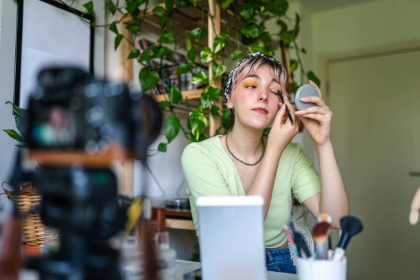 Young Woman vlogging about makeup at home stock photo