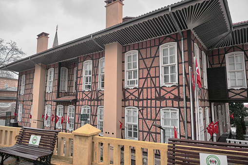 29.03.2021. Bursa. Turkey. Old ottoman style pavilion in center of the Bursa capital city of ottoman empire. Old pavilion, street bench and overcast sky during rainy day