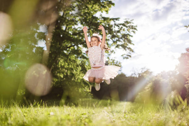 istock Beautiful girl jumping in nature 1326925541