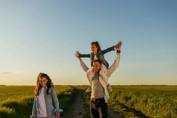 istock Happy family walking in the fields 1326925583