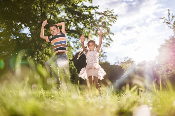 istock Beautiful children jumping in nature 1326925594