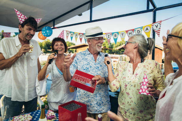 istock Senior people celebrating birthday singing karaoke. 1326927877