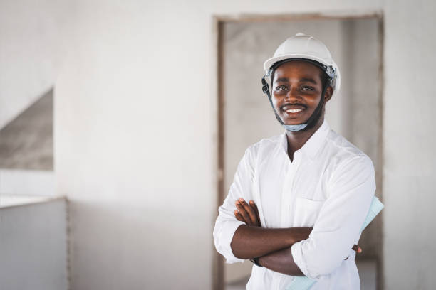 istock African man construction engineer worker standing and looking the unfinished building 1326929931