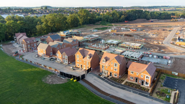 Aerial view of new build housing construction site in England, UK Aerial view looking down on new build housing construction site in England, UK council flat stock pictures, royalty-free photos & images