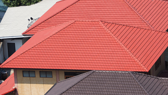 Half round clay tile roof tops on generic modern building in southwest florida
