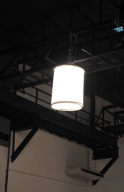 istock Flood light is hanging on ceiling. Light set up for shooting. Studio Hanging Light Tent equipment or big lamp for movie shooting and flare of light in camera. Film industry. 1326931660