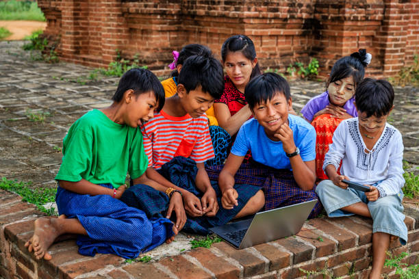 istock Burmese children using laptop in temple, Old Bagan, Myanmar 1326931696