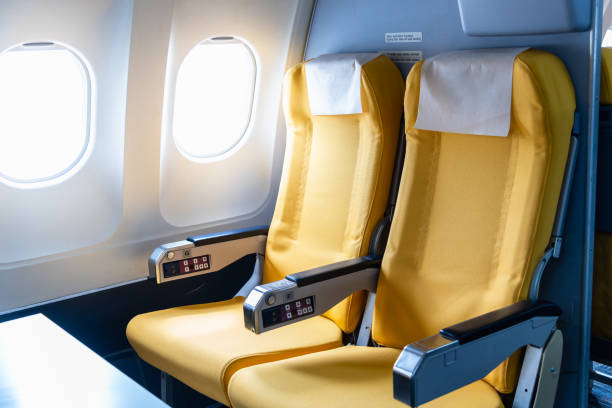 istock Empty yellow color airplane seat with airplane window. 1326931723