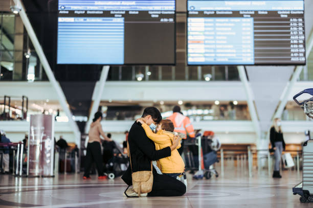 istock Mother hugging her son after arriving from trip 1326931936