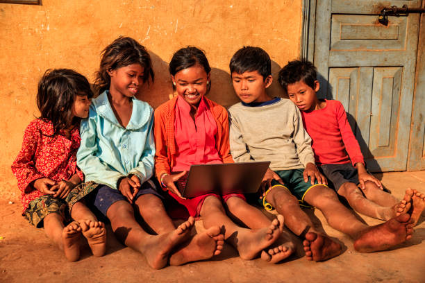 istock Happy Cambodian children using laptop on a schoolyard, Cambodia 1326932154