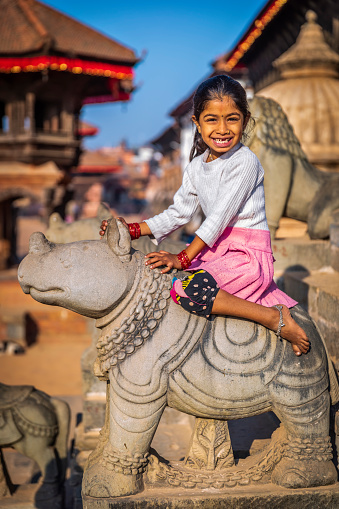 istock Little nepali girl having fun on Hindu temple in Bhaktapur 1326932745