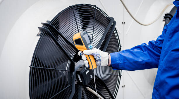 istock Technician uses a thermal imaging infrared thermometer to check the condensing unit heat exchanger. 1326935077