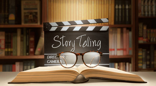 Storytelling concept.Film slate,old book and eyeglasses in library room storytelling, Filmmaker, or content creator concept. cinematography stock pictures, royalty-free photos & images