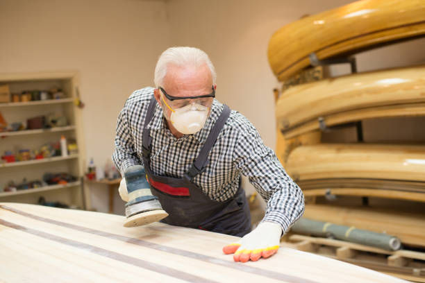 istock Senior man carpenter making wooden boat in his workshop 1326937318