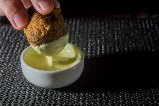 istock hand putting fried dumpling in a pot with mayonnaise ,copy space and dark background 1326938603