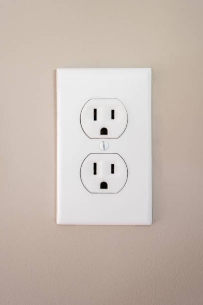 Photograph of an electrical wall outlet with faceplate A 115 amp white wall outlet with a face plate plugging in photos stock pictures, royalty-free photos & images