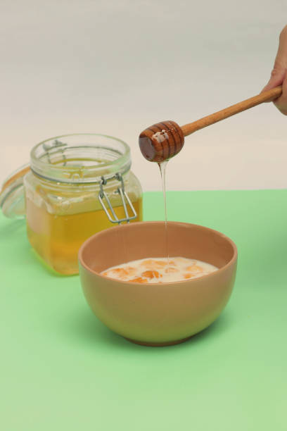 istock Flakes in milk for breakfast with honey on a light background. Breakfast concept. 1326939840