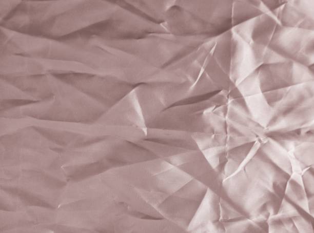 istock wrinkled pink satin fabric texture 1326942084