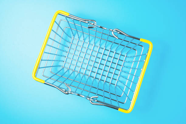 istock Empty shopping basket on blue background, top view. Shopping concept. 1326942111