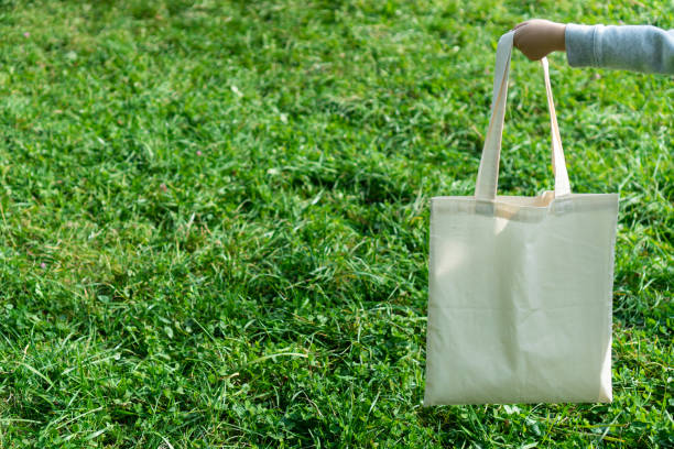 istock Eco friendly canvas shopping bag on green grass background. Zero waste concept. 1326943150