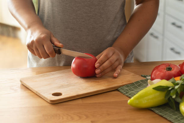 istock Ingredients for making Spanish gazpacho soup. Step by step instructions for cooking. Step 2 - slicing tomatoes 1326944126