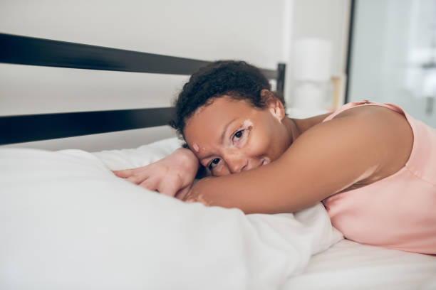 istock Young woman lying in bed and feeling peaceful 1326945767