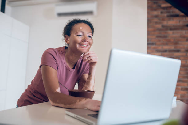 istock Young mulatta watching something on internet and smiling 1326946262