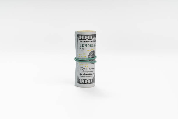 istock a pack of dollars tied with a rubber band on a white background. 1326947848