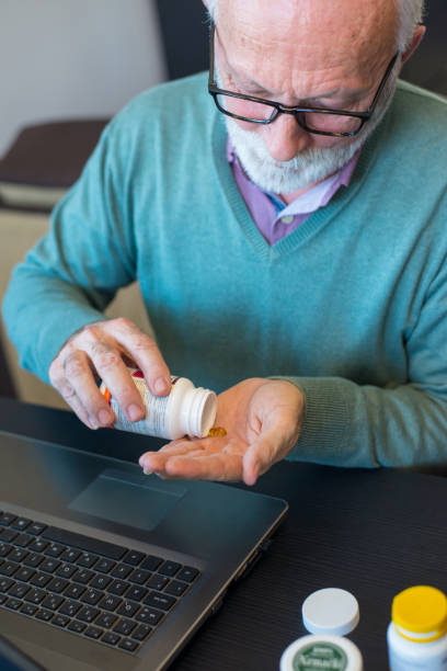 istock Senior man taking his pills 1326947860
