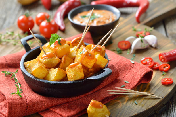 Hot Spanish tapas Spanish patatas bravas with spicy chili sauce, a traditional appetizer and bar food patatas bravas stock pictures, royalty-free photos & images
