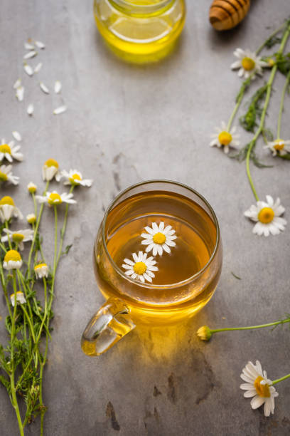 istock A glass mug with chamomile tea on a rustic background 1326947907